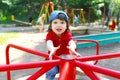 Cute little boy on carrousel in summer Royalty Free Stock Photo