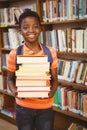 Cute little boy carrying books in library Royalty Free Stock Photo