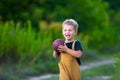 Cute little boy in casual clothes playing with ball