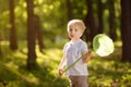 Cute little boy catches butterflies with scoop-net on sunny meadow.Study of nature. Young naturalist Royalty Free Stock Photo