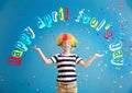 Cute little boy with clown makeup and falling confetti on color background. April fools\' day celebration