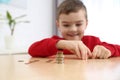 Cute little boy with coins at home. Counting money Royalty Free Stock Photo