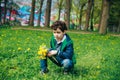 Cute little boy with dandelions in park on warm spring day, Royalty Free Stock Photo