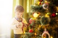 Cute little boy decorating Christmas tree at home Royalty Free Stock Photo