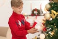 Cute little boy decorating Christmas tree at home Royalty Free Stock Photo