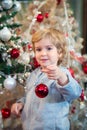 Cute little boy decorating Christmas tree. Royalty Free Stock Photo