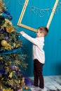 Cute little boy decorating christmas tree. Young kid in light bedroom with winter decoration. Happy family at home. Christmas New Royalty Free Stock Photo