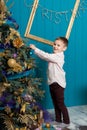 Cute little boy decorating christmas tree. Young kid in light bedroom with winter decoration. Happy family at home. Christmas New Royalty Free Stock Photo