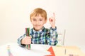 Cute little boy drawing at home. Children`s creativity. Creative kid painting at preschool. Development and education concept.