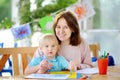 Cute little boy drawing and painting with colorful markers pens at kindergarten Royalty Free Stock Photo