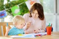 Cute little boy drawing and painting with colorful markers pens at kindergarten Royalty Free Stock Photo