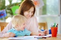 Cute little boy drawing and painting with colorful markers pens at kindergarten Royalty Free Stock Photo