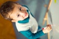 Cute little boy drawing on white board with felt pen and smiling Royalty Free Stock Photo