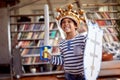 A cute little boy dressed as knight is posing for a photo while playing at home. Family, home, playtime