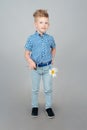 A cute little boy is dressed in a checked blue shirt. A kid with