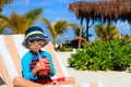Cute little boy drinking juice on the beach Royalty Free Stock Photo