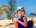 Cute little boy drinking juice on the beach Royalty Free Stock Photo