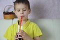 Cute little boy drinking juice at home, cherry juice drinks from a bottle or a glass with a straw. Royalty Free Stock Photo