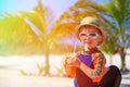 Cute little boy drinking juice on tropical beach Royalty Free Stock Photo