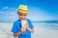 Little boy drinking juice on tropical summer beach Royalty Free Stock Photo