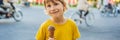 Cute little boy, eating big ice cream in the park, smiling at camera, summertime BANNER, LONG FORMAT Royalty Free Stock Photo