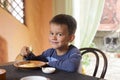 Cute little boy eating breakfast Royalty Free Stock Photo