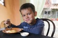 Cute little boy eating breakfast Royalty Free Stock Photo