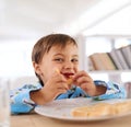 I love jam on toast the most. A cute little boy eating breakfast. Royalty Free Stock Photo