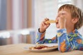 Tasty toast. A cute little boy eating breakfast. Royalty Free Stock Photo