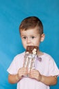 Cute Little Boy Eating Chocolate Bar. Very cute kid with chocolate, isolated. Royalty Free Stock Photo