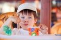 Cute little boy eating ice cream at indoor cafe Royalty Free Stock Photo