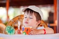 Cute little boy eating ice cream at indoor cafe Royalty Free Stock Photo