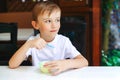 Cute little boy eating ice cream at outdoor cafe. Happy childhood. Summer holidays Royalty Free Stock Photo