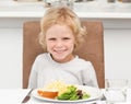 Cute little boy eating pasta and salad Royalty Free Stock Photo