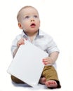 Cute little boy with empty white paper in his hands. Mock-up Royalty Free Stock Photo