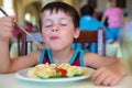 Cute little boy enjoying food