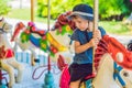 Cute little boy enjoying in funfair and riding on colorful carousel house Royalty Free Stock Photo