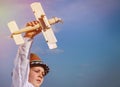 Cute little boy flying his toy biplane Royalty Free Stock Photo