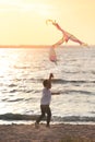 Cute little boy flying kite near river at sunset Royalty Free Stock Photo