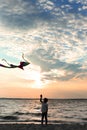 Cute little boy flying kite near river at sunset Royalty Free Stock Photo