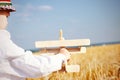 Cute little boy flying a toy plane in a wheatfield Royalty Free Stock Photo