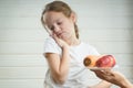 Cute little boy frowning over his meal while playing with toys. Bad behavior, eating habbits concept