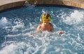 Cute little boy in funny sunglasses in pool in sunny day. Royalty Free Stock Photo