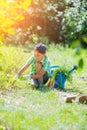 Cute little boy gardening with a watering can in domestic garden. Royalty Free Stock Photo