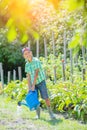 Cute little boy gardening with a watering can in domestic garden. Royalty Free Stock Photo