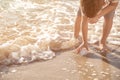 Cute little boy gathering sea shells on beach Royalty Free Stock Photo