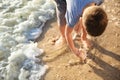 Cute little boy gathering sea shells on beach Royalty Free Stock Photo