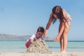 Cute little boy and a girl building a sand castle on a tropical sea shore Royalty Free Stock Photo