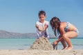 Cute little boy and a girl building a sand castle on a tropical sea shore Royalty Free Stock Photo