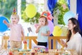 Cute little boy and girl celebrate birthday party with colorful decoration and cakes. Royalty Free Stock Photo